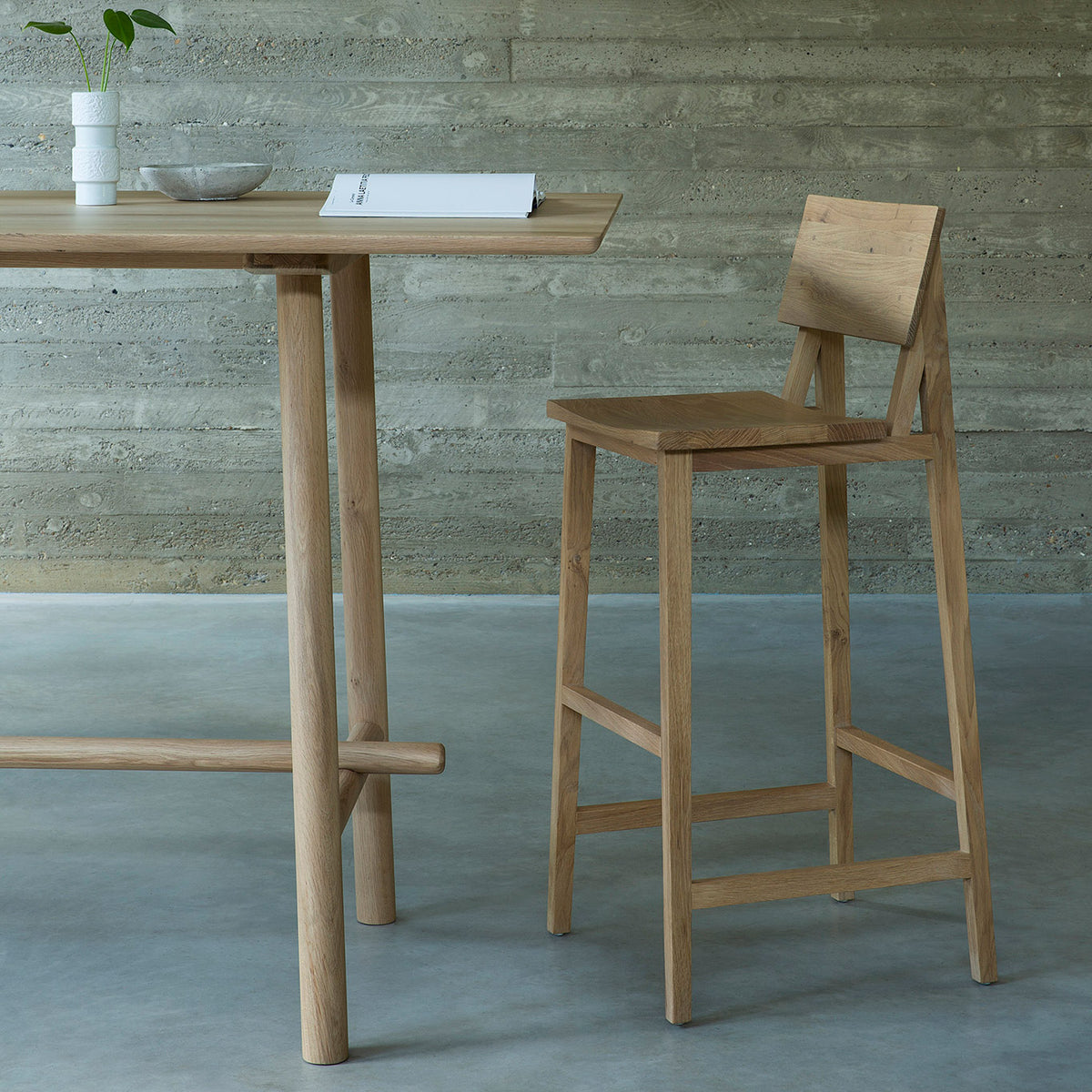 N4 Bar Stool by Ethnicraft, showing angle view of n4 bar chair in live shot.