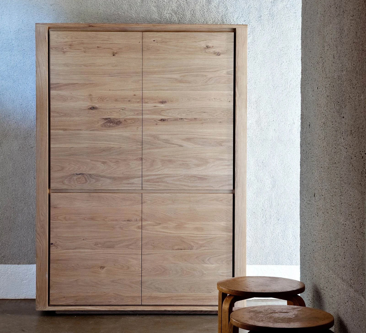 Shadow Storage Cupboard by Ethnicraft, showing front view of oak storage cupboard in live shot.