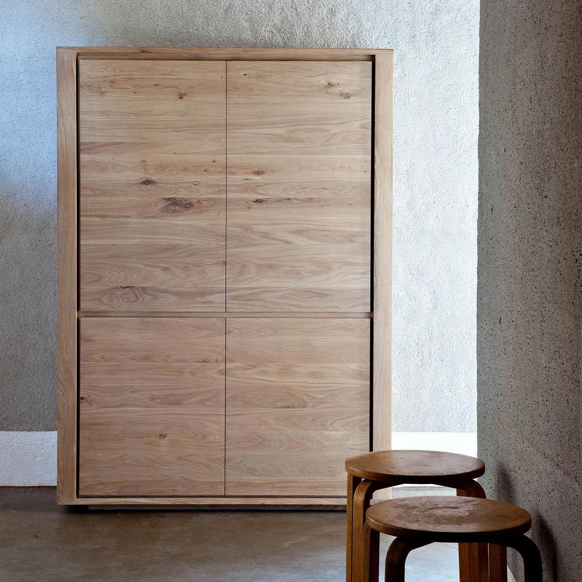 Shadow Storage Cupboard by Ethnicraft, showing front view of oak storage cupboard in live shot.
