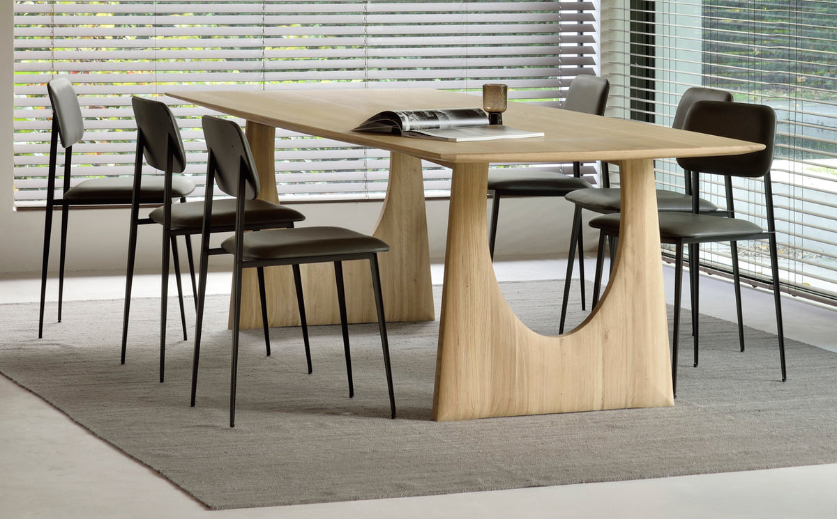 Geometric Dining Table by Ethnicraft, showing angle view of geometric dining table with chairs in live shot.