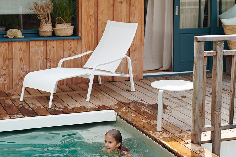 Alize Stacking Low Table by Fermob, showing stacking low tables with sunloungers in live shot.
