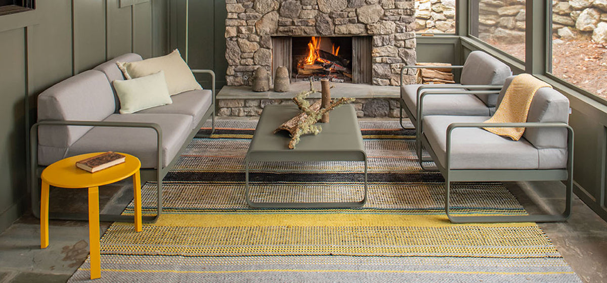 Alize Stacking Low Table by Fermob, showing stacking low tables with sofa in live shot.