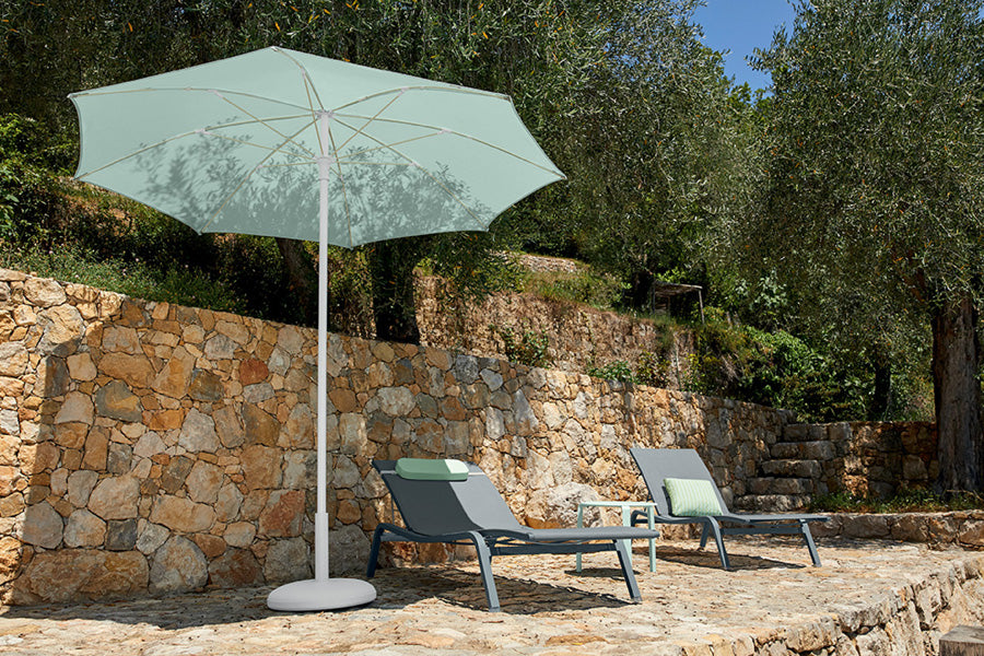 Alize Stacking Low Table by Fermob, showing stacking low tables with sunloungers in live shot.