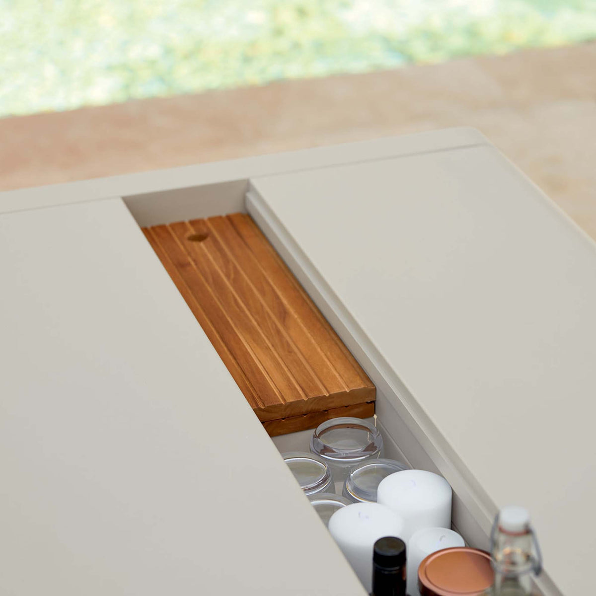 Bellevie Table with Storage by Fermob, showing closeup view of bellevie table with storage in live shot.