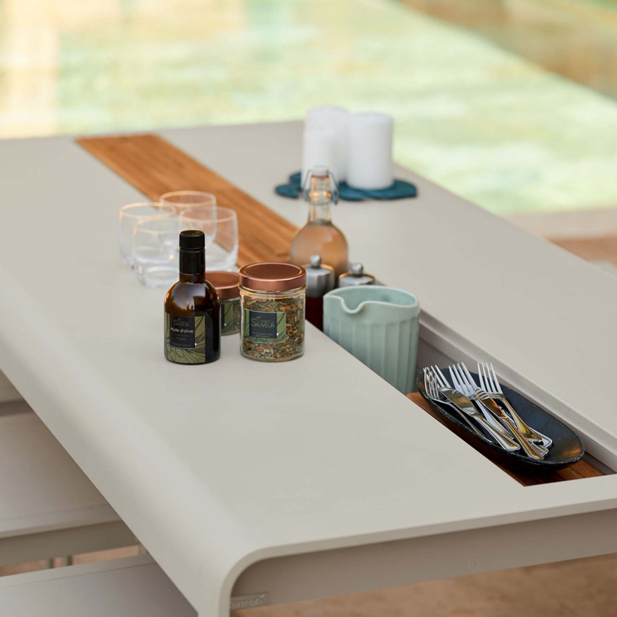 Bellevie Table with Storage by Fermob, showing closeup view of bellevie table with storage in live shot.