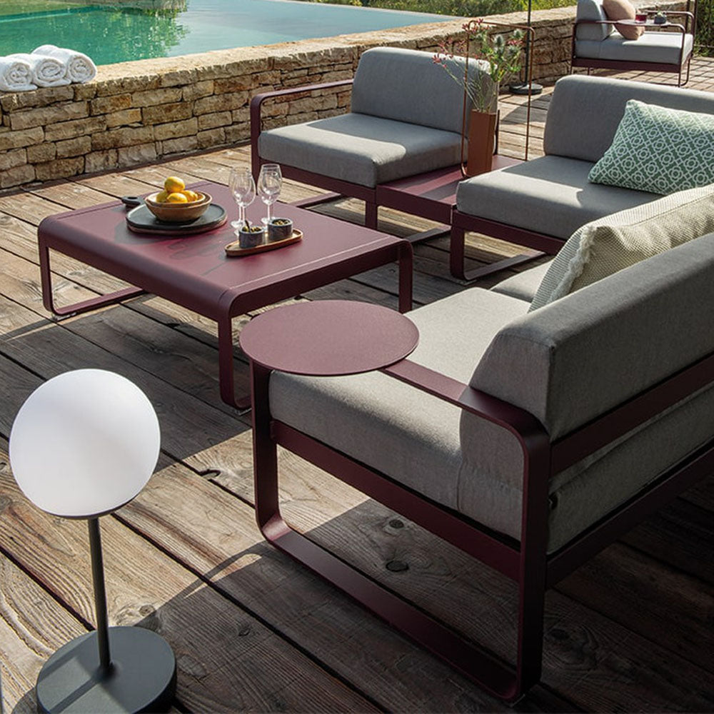 Bellevie Armrest Shelf by Fermob, showing bellevie armrest shelf with sofa in live shot.