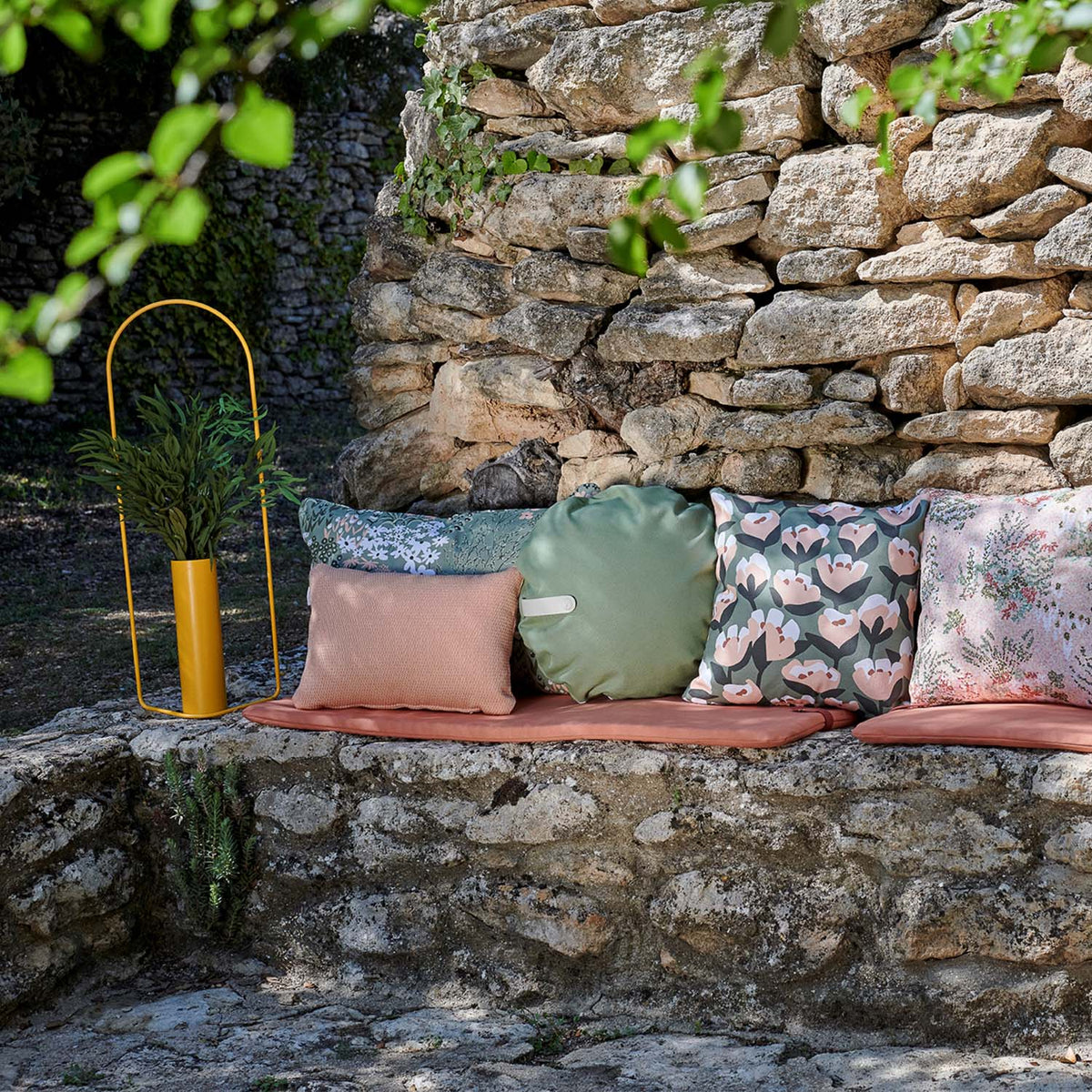 Color Mix Bench Outdoor Cushion by Fermob, showing color mix bench outdoor cushion in live shot.
