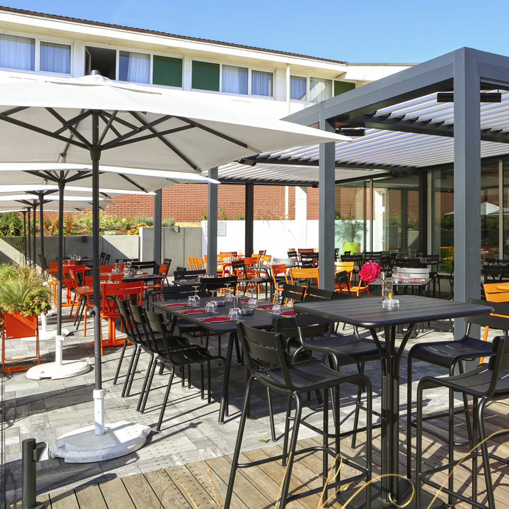 Luxembourg High Pedestal Table by Fermob, showing luxembourg high pedestal table in live shot.