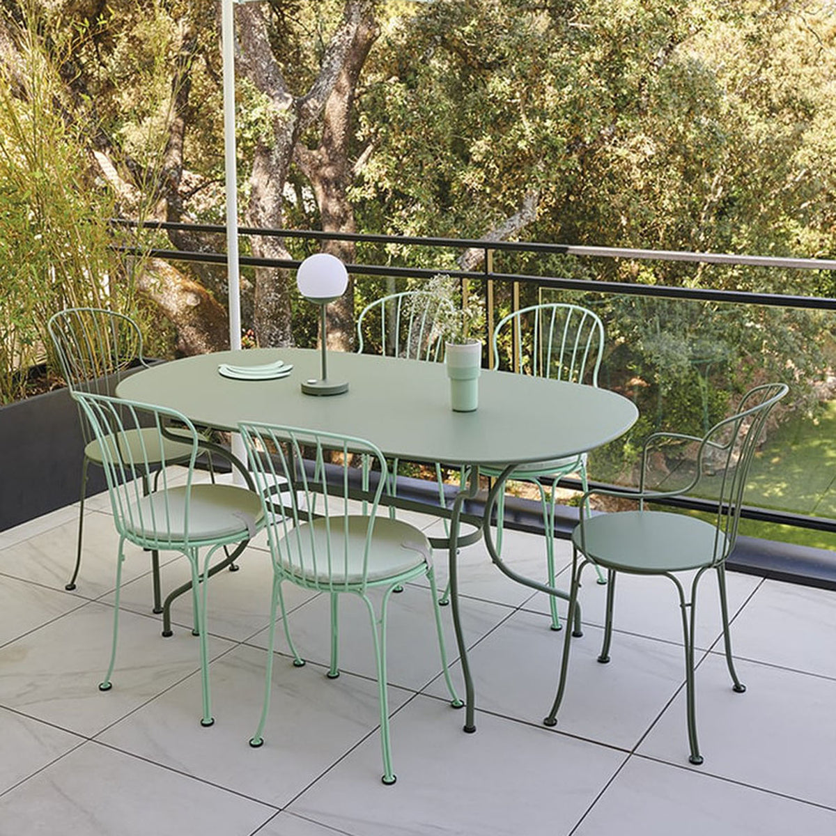 Opera+ Oval Table by Fermob, showing opera+ oval table in live shot.