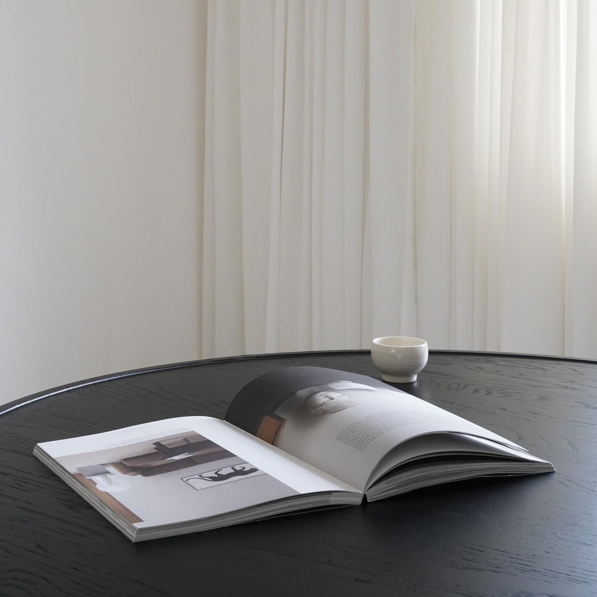 Accent Dining Table by Mater, showing closeup view of accent dining table in live shot.