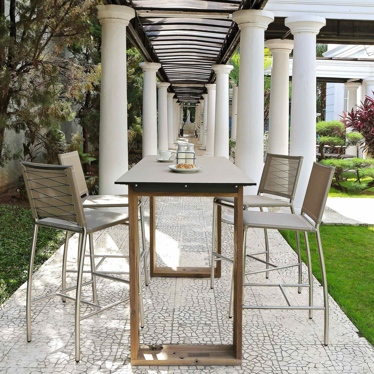 Aiko Bar Table by Mamagreen, showing bar table with bar chairs in live shot.