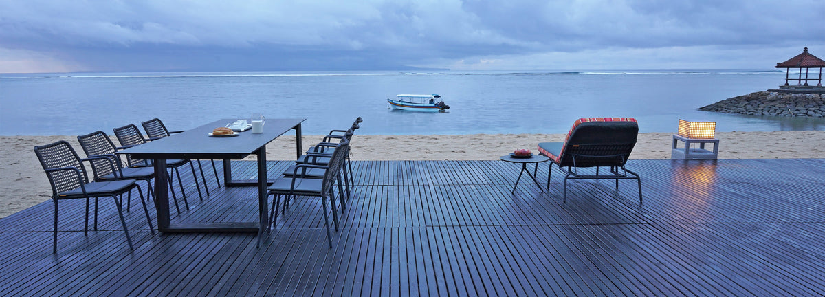 Aiko Dining Table by Mamagreen, showing showing aiko dining table with chairs in live shot.