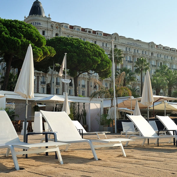 Alize Stacking Low Table by Fermob, showing stacking low tables with sunloungers in live shot.