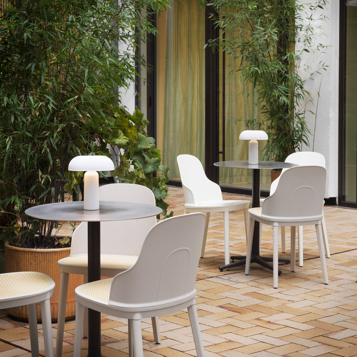 Allez PP Dining Chair Molded Wicker Seat by Normann Copenhagen, showing allez pp dining chairs molded wicker seat with tables in live shot.