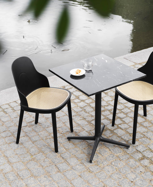 Allez PP Dining Chair Molded Wicker Seat by Normann Copenhagen, showing allez pp dining chairs molded wicker seat with table in live shot.