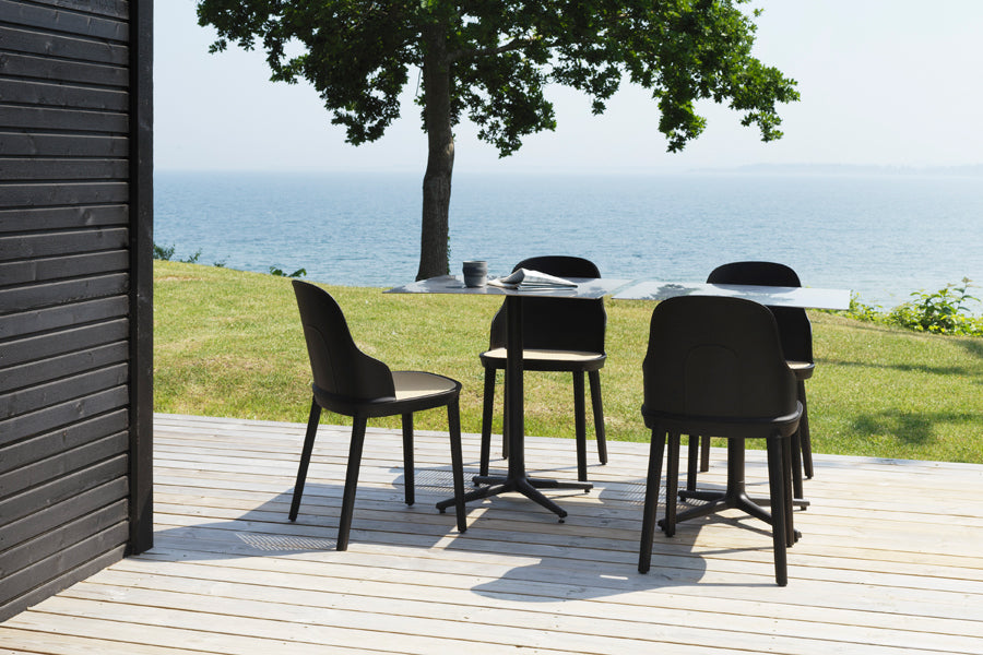 Allez PP Dining Chair Molded Wicker Seat by Normann Copenhagen, showing allez pp dining chairs molded wicker seat with table in live shot.