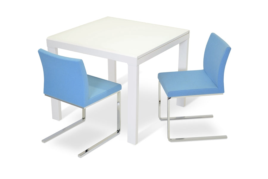 Aria Flat Chair by SohoConcept, showing angle view of the chair with table.