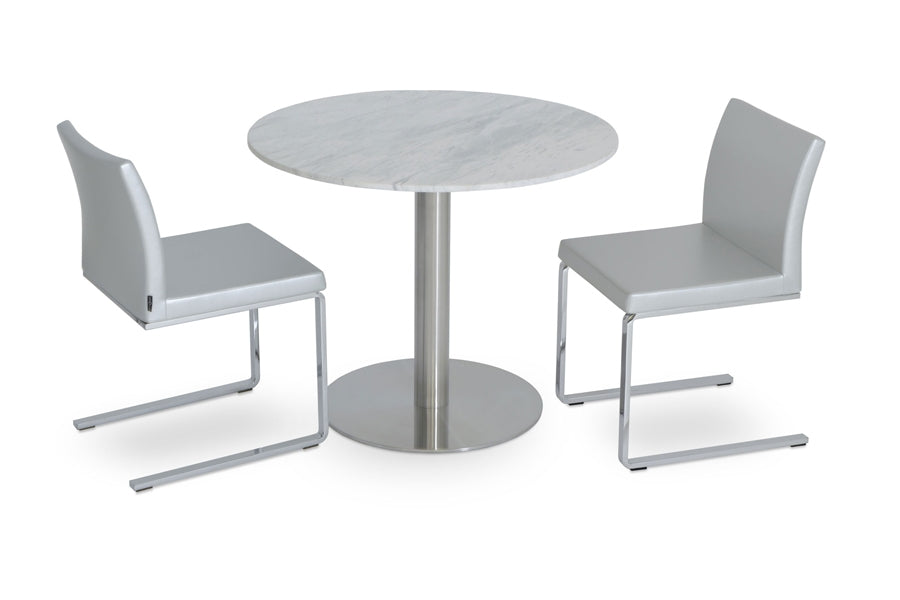 Aria Flat Chair by SohoConcept, showing angle view of the chair with table.