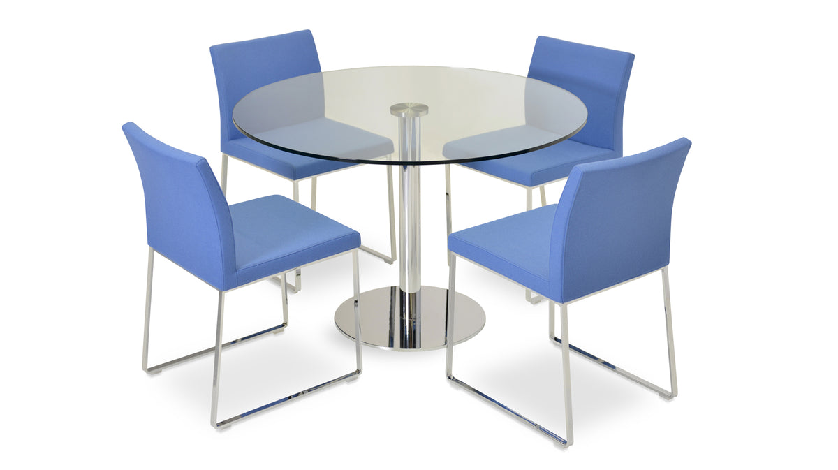 Aria Sled Wire Dining Chair by SohoConcept, showing sleg dining chairs with table.