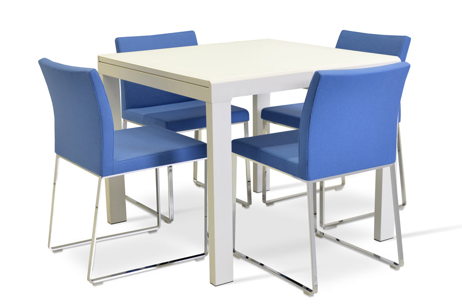 Aria Sled Wire Dining Chair by SohoConcept, showing sleg dining chairs with table.