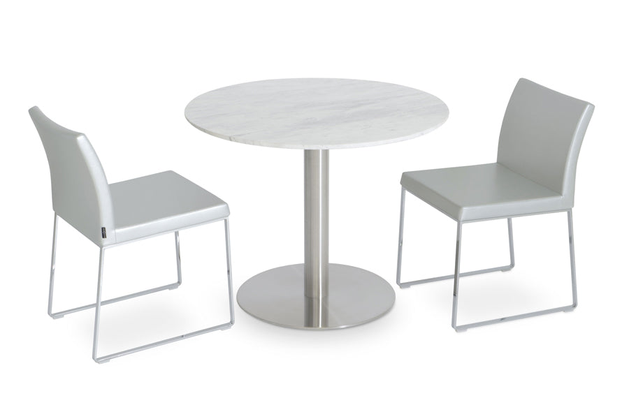 Aria Sled Wire Dining Chair by SohoConcept, showing sleg dining chairs with table.