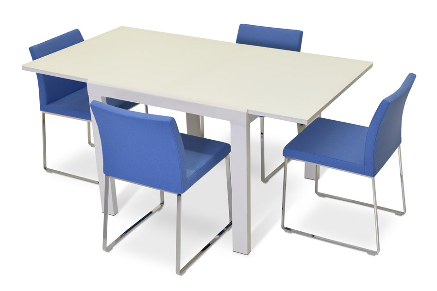 Aria Sled Wire Dining Chair by SohoConcept, showing sleg dining chairs with table.