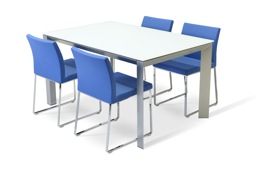 Aria Sled Wire Dining Chair by SohoConcept, showing sleg dining chairs with table.
