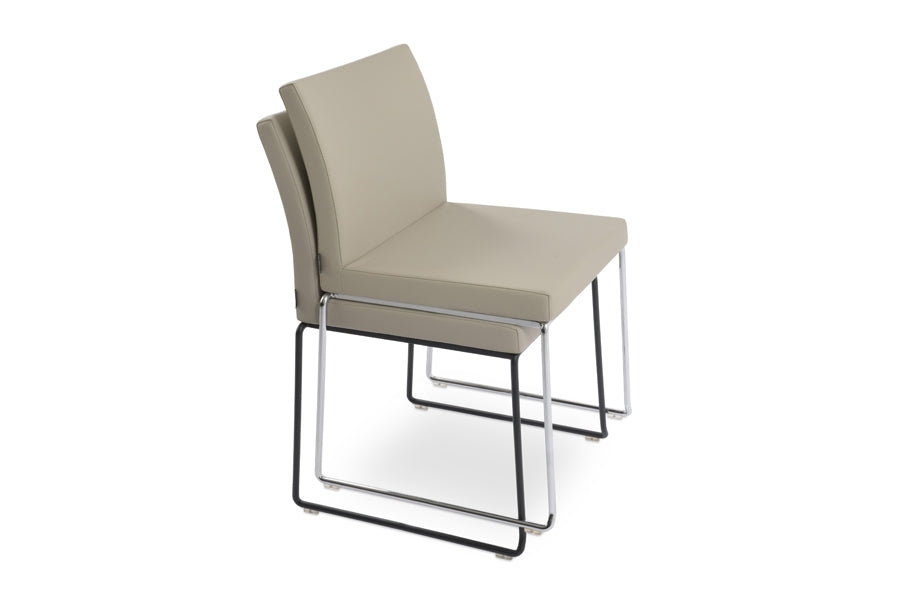 Aria Stackable Dining Chair by sohoConcept, shown in light grey leatherette.