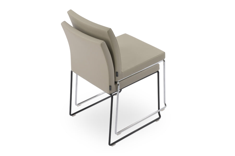 Aria Stackable Dining Chair by sohoConcept, shown in light grey leatherette.