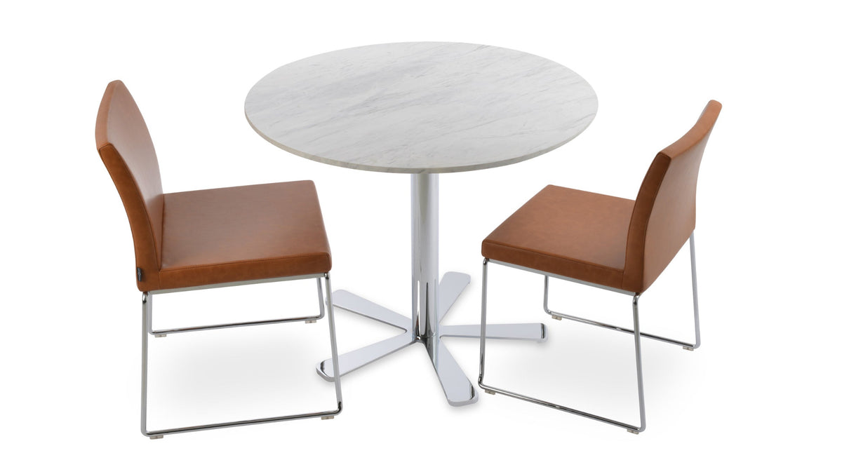 Aria Stackable Dining Chair by sohoConcept, showing chairs in caramel ppm with chrome base & daisy marble dining table.