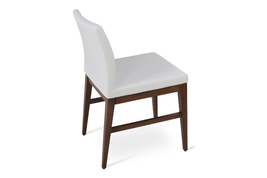 Aria Wood Stretcher Dining Chair by SohoConcept, showing side view of aria wood stretcher dining chair in beech walnut wood/white leatherette.