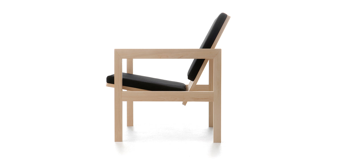 Arkitecture YKA1 Lounge Chair by Nikari, showing side view of arkitecture yka1 lounge chair in fabric 2: steelcut trio by kvadrat.