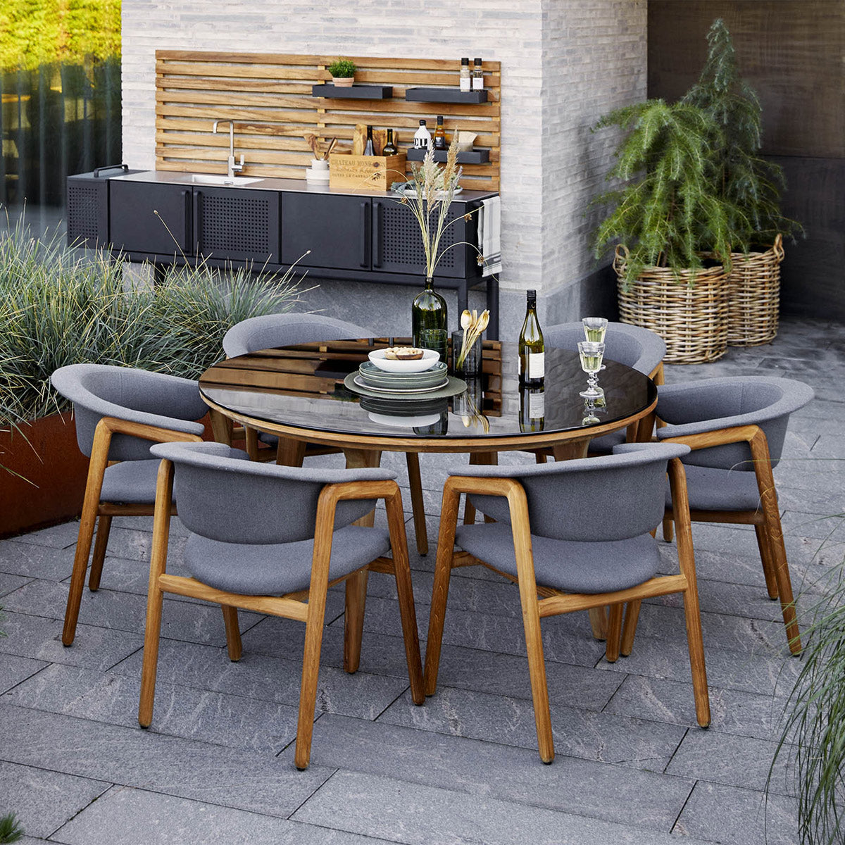 Aspect Outdoor Dining Table by Cane-Line, showing aspect outdoor dining table with chairs in live shot.