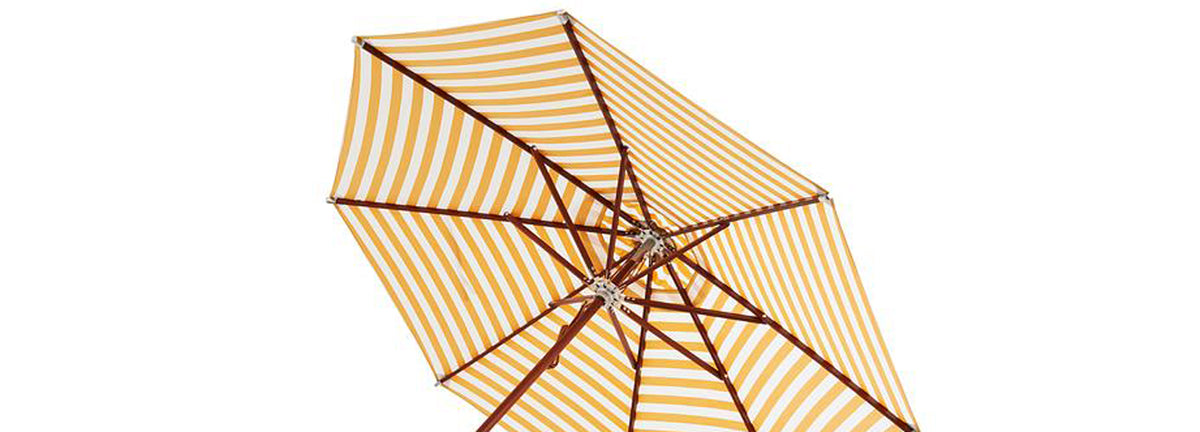Atlantis Stripes Outdoor Umbrella Ø330 by Skagerak, showing closeup view of atlantis stripes outdoor umbrella in golden yellow stripes fabric.