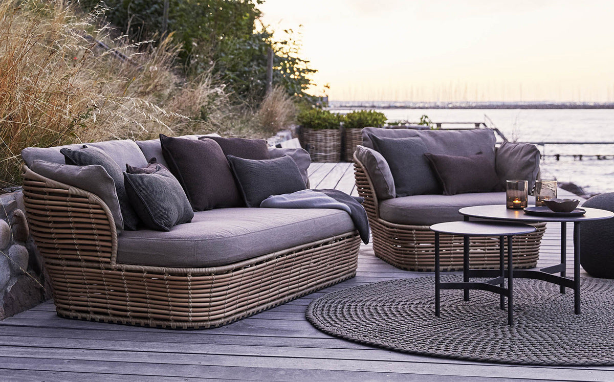 Basket 2-Seater Sofa by Cane-Line, showing of basket 2-seater sofa with chair & table in live shot.