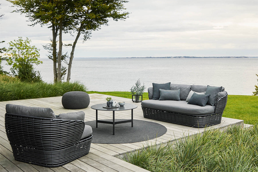 Basket Lounge Chair by Cane-Line, showing of basket lounge chair with tables & sofa in live shot.