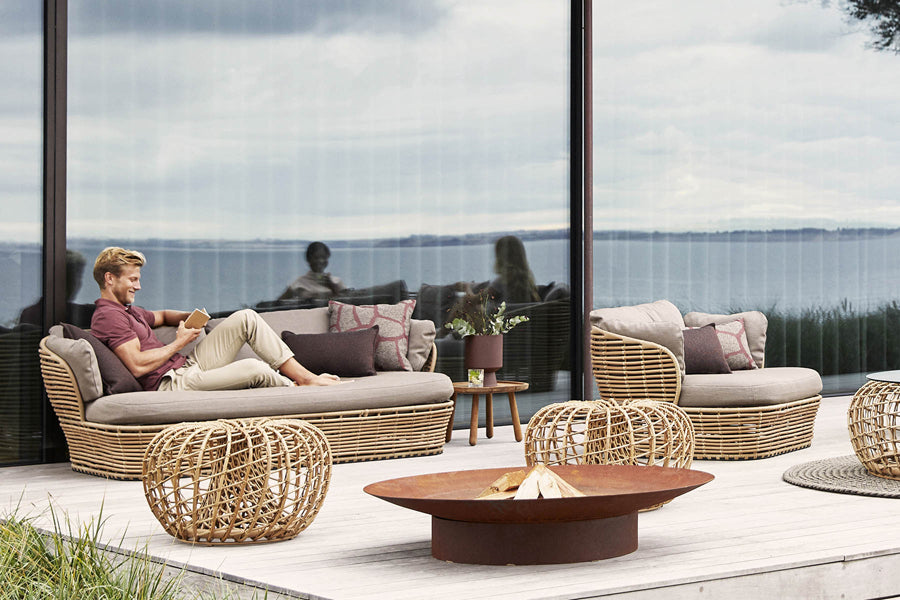 Basket Lounge Chair by Cane-Line, showing of basket lounge chair with table & sofa in live shot.