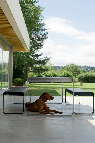 Bellevie Bench by Fermob, showing side view of the bench with dining table.