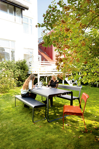 Bellevie Bench by Fermob, showing live shoot of the bench with dining table.