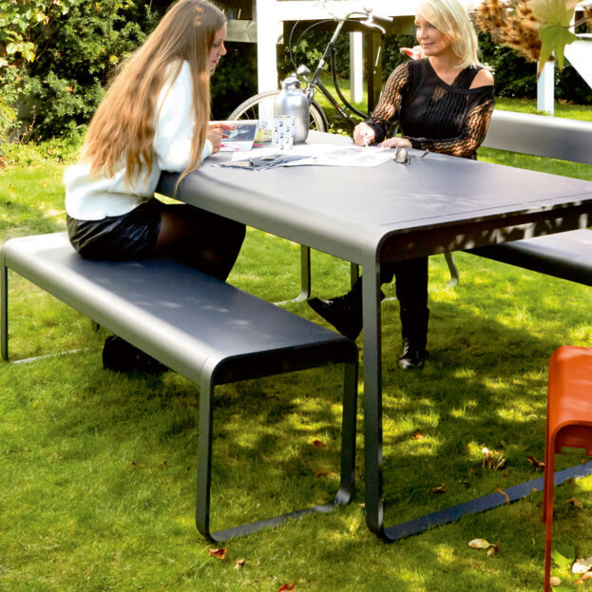 Bellevie Bench by Fermob, showing live shoot of the bench with dining table.