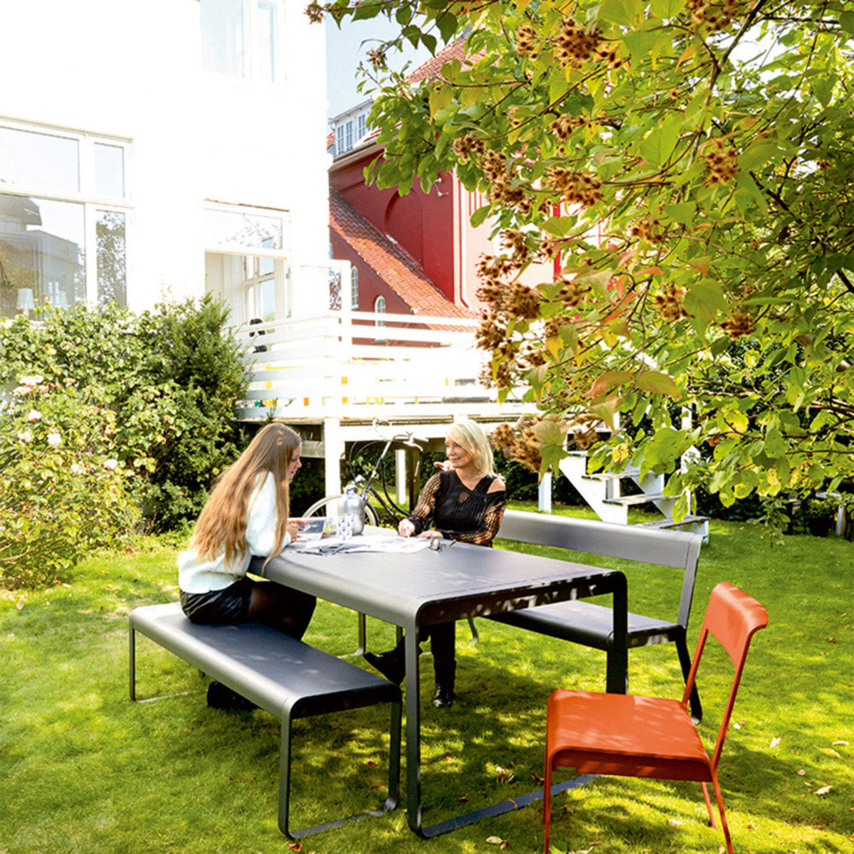 Bellevie Bench with Back by Fermob, showing of bellevie bench with back and table in live shot.
