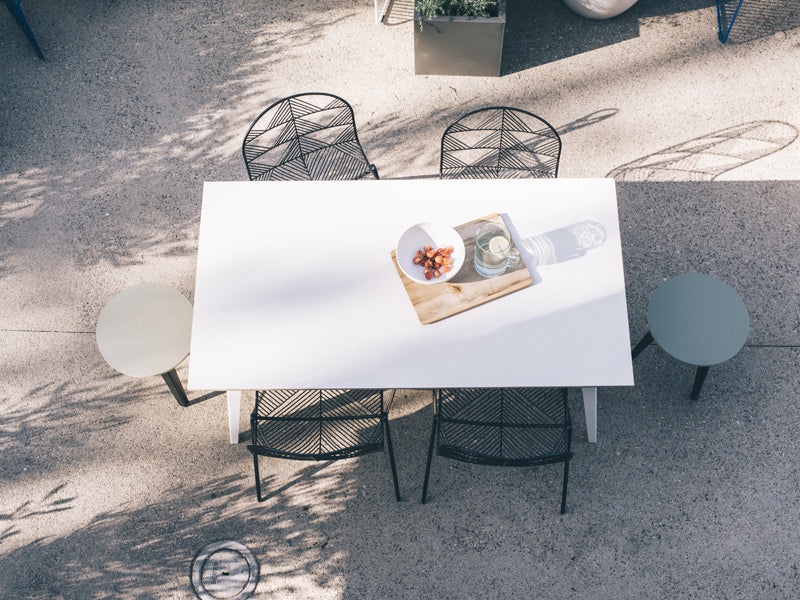 Betty Stacking Chair by Bend, showing betty stacking chairs with table in live shot.