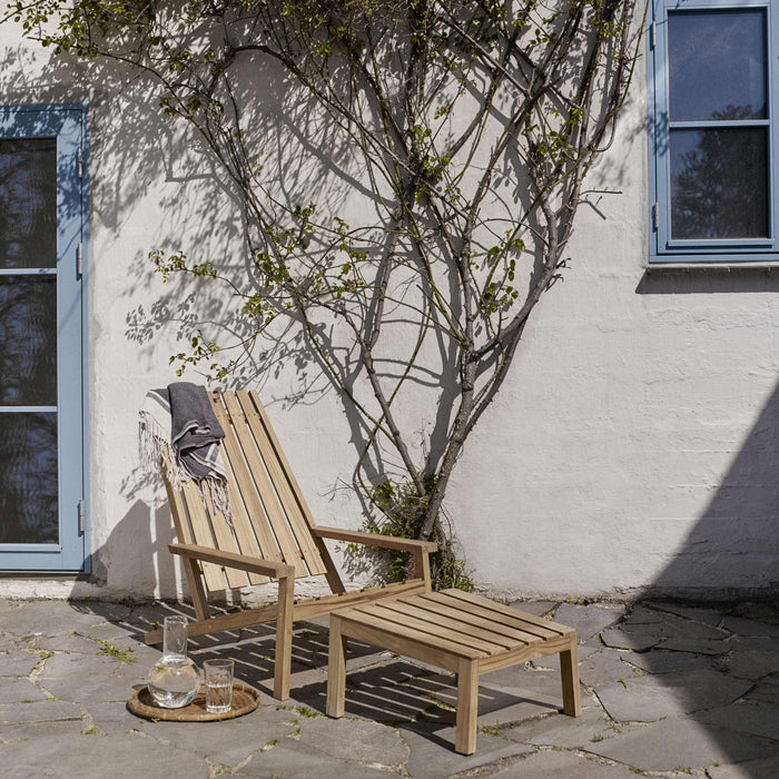 Between Lines Deck Chair by Skagerak, showing between lines deck chair with stool in live shot.