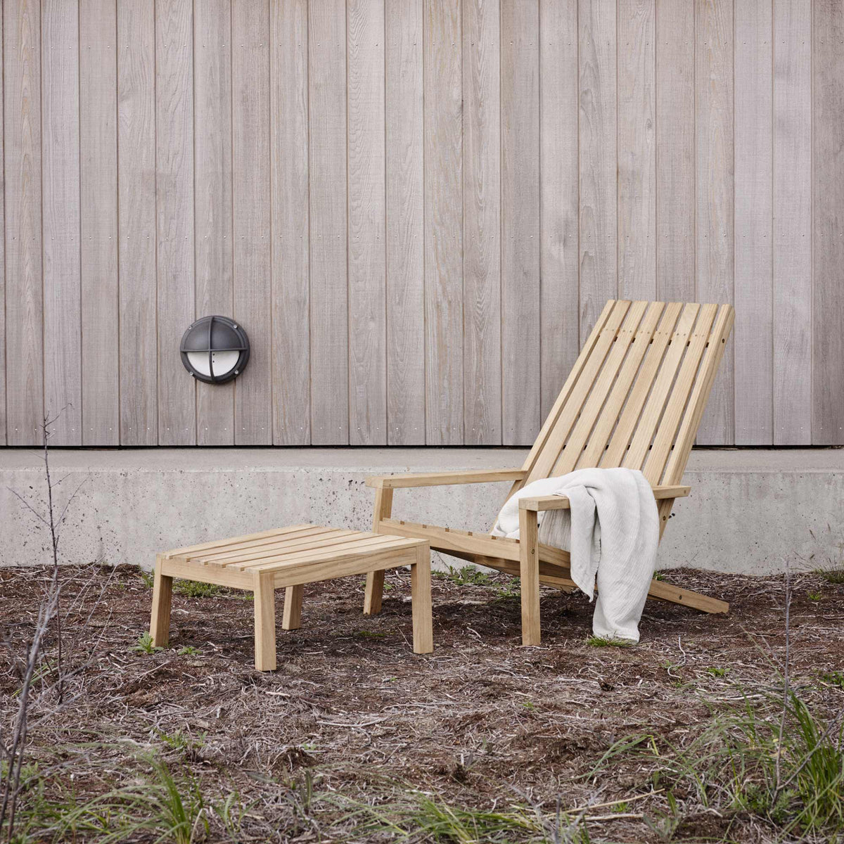 Between Lines Deck Chair by Skagerak, showing between lines deck chair with stool in live shot.