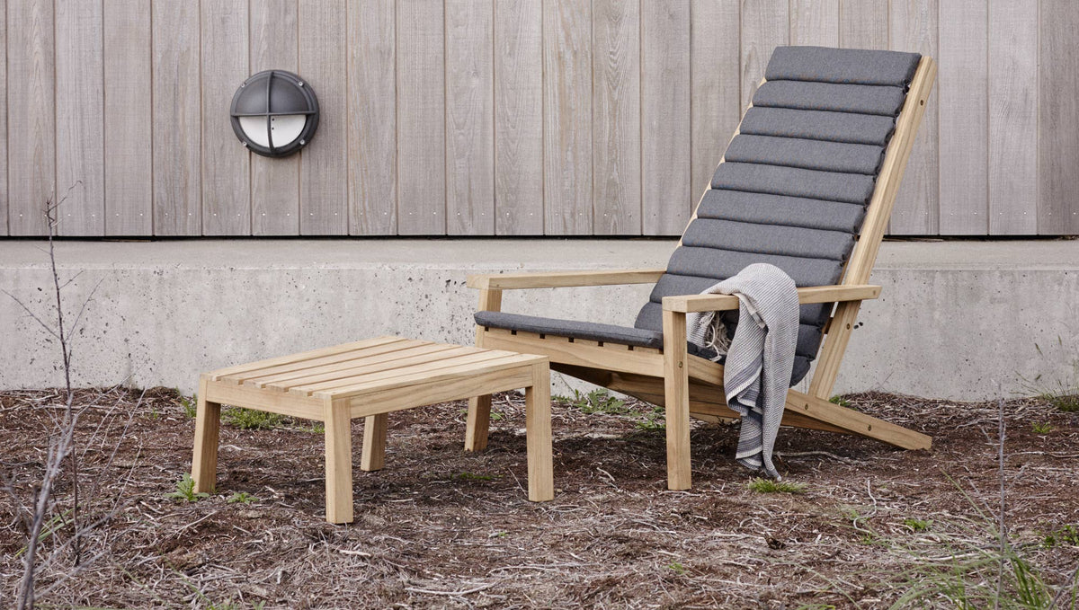 Between Lines Deck Stool by Skagerak, showing between lines deck stool with deck cushion chair in live shot.