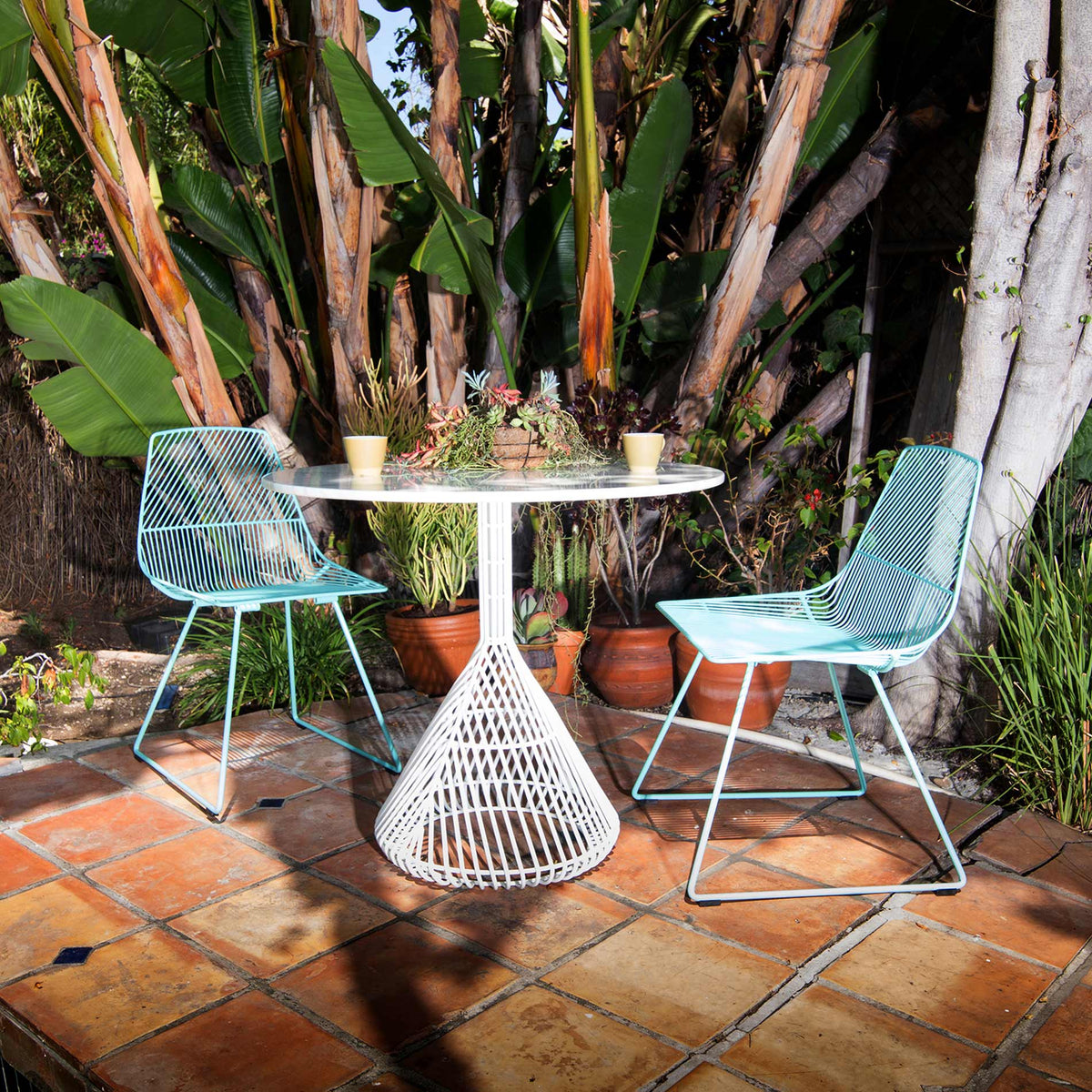 Bistro Base Table by Bend, showing bistro base table with chairs in live shot.