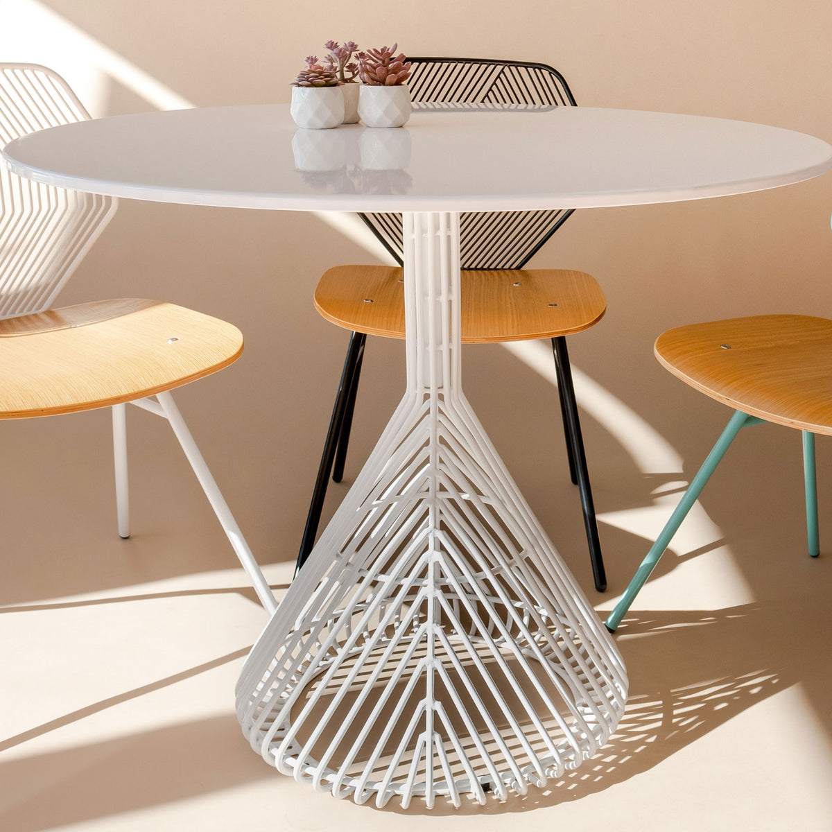 Bistro Base Table by Bend, showing bistro base table with chairs in live shot.