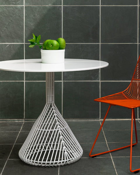 Bistro Base Table by Bend, showing bistro base table with chair in live shot.