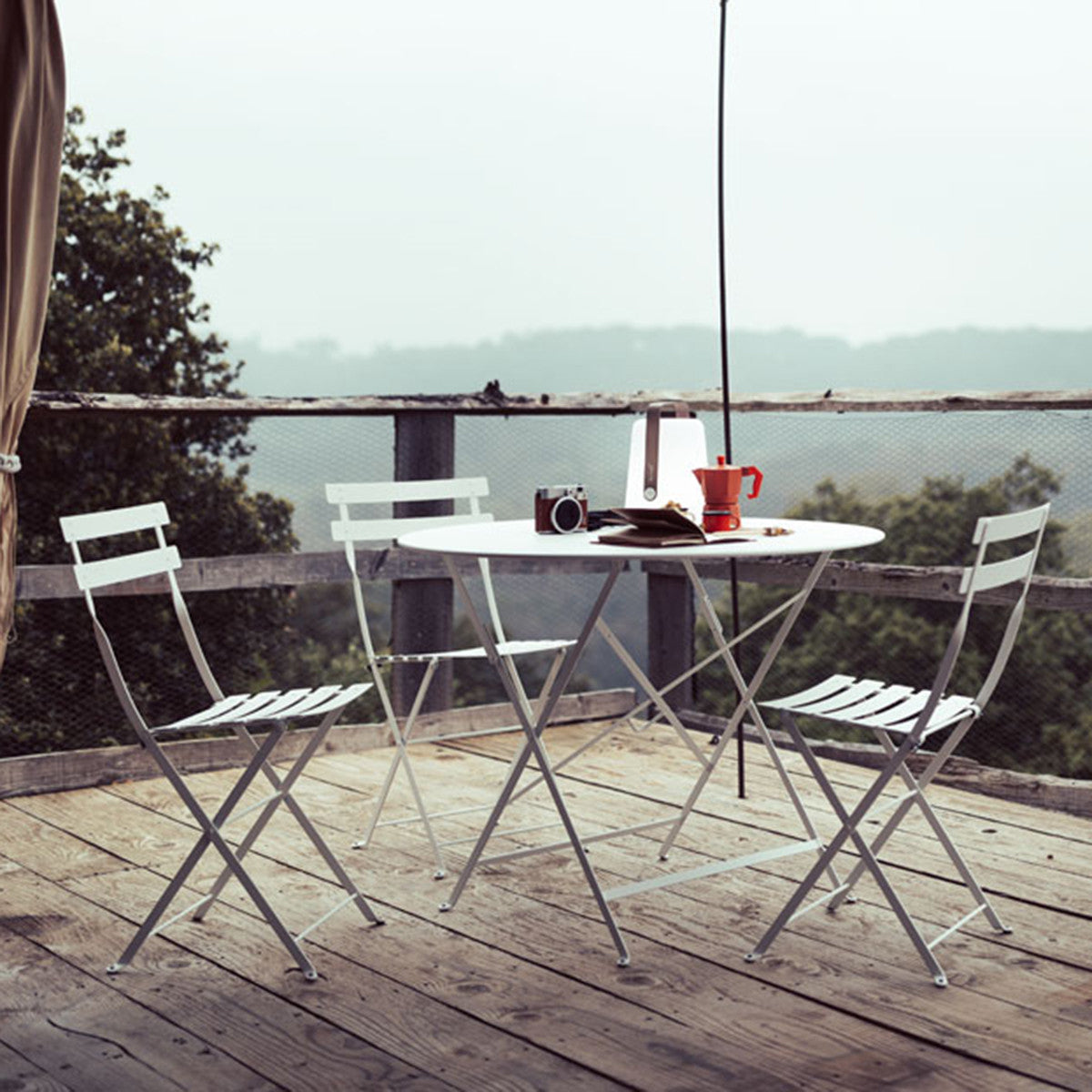 Bistro Metal Chair by Fermob, showing bistro metal chairs with table in live shot.