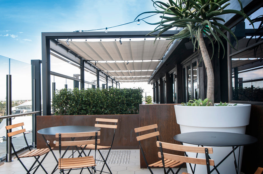 Bistro Round Tables by Fermob, showing live shoot of the table with chairs.
